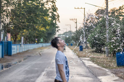 Boy standing on street in city