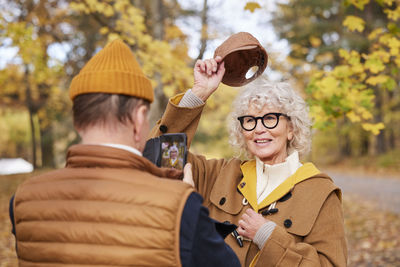 Man photographing woman