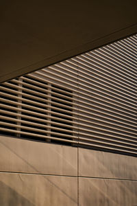 Low angle view of metal grate on wall