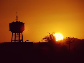 Silhouette of built structure at sunset