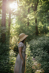 Side view of woman in forest