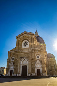 Low angle view of historical building against blue sky