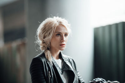 Portrait of young woman looking away outdoors