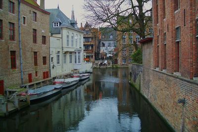 Boats in canal along buildings