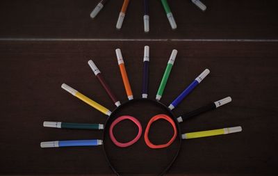 Directly above shot of multi colored pencils on table against black background
