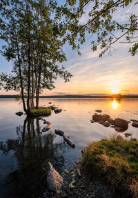 Scenic view of lake against sky at sunset