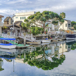 Boats in swimming pool against buildings in city