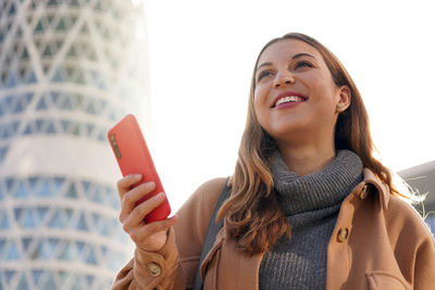 Portrait of young woman using mobile phone