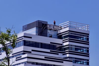 Low angle view of office building against blue sky