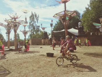 People riding bicycle on street in city