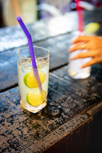 Cocktail with lime in tumbler glass