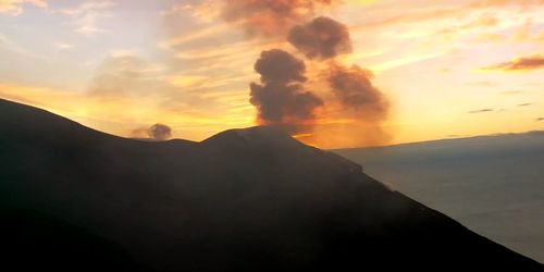 Scenic view of silhouette mountains against sky during sunset