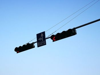 Low angle view of road sign against clear sky