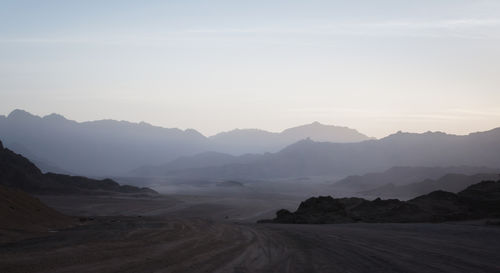 Scenic view of landscape and mountains against sky