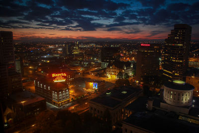 High angle view of illuminated buildings against sky at night