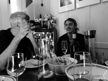 Portrait of man with father sitting at table in restaurant