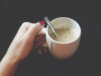 Close-up of hand holding coffee cup