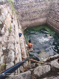 High angle view of man swimming on rock