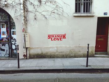 Text on footpath by building in city