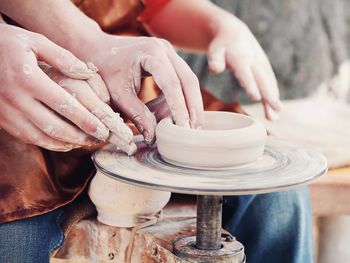 Cropped hands making clay product at pottery