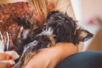 Midsection of woman carrying puppy