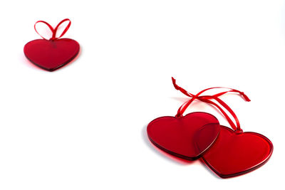 Close-up of red heart shape over white background