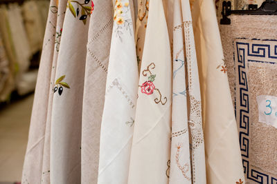 Close-up of tablecloth hanging on rack at store