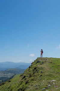 Man on mountain road against sky