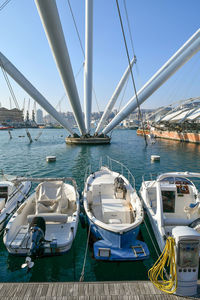 Boats moored on sea against clear sky