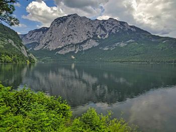 Scenic view of lake and mountains against sky