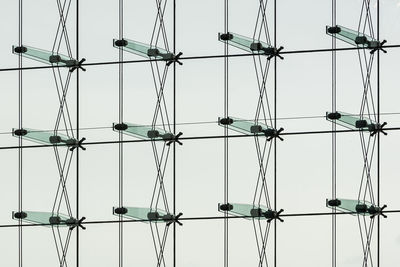 Low angle view of cranes against sky