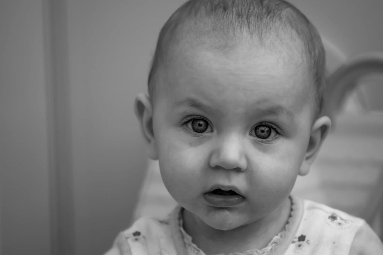 baby, real people, headshot, portrait, looking at camera, close-up, focus on foreground, lifestyles, one person, front view, indoors, babyhood, childhood, human body part, fragility, day, people