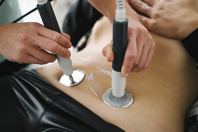 Midsection of man working on table