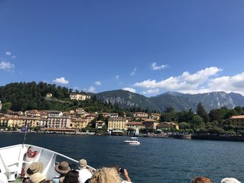 Scenic view of river by buildings against sky