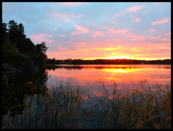 Scenic view of lake at sunset