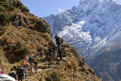 Trekking tourists climbing everest trek in nepal