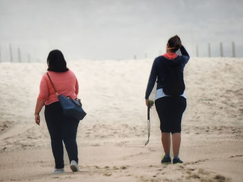 Rear view of women on beach