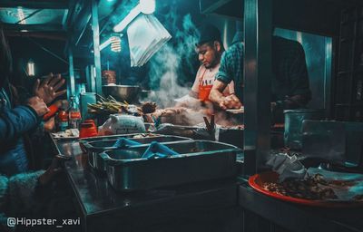 People working at market stall