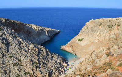 High angle view of mountains by sea