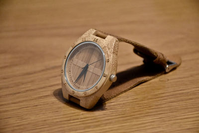 High angle view of clock on wooden table