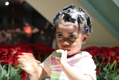 Close-up of cute girl with finger in mouth