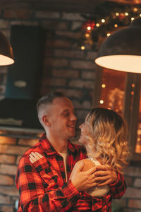 Candid authentic happy married couple spends time alone at lodge xmas decorated