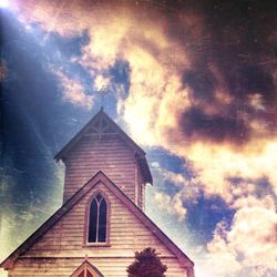 Low angle view of church against cloudy sky