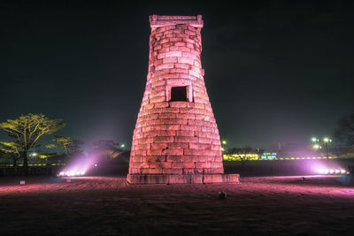 Low angle view of illuminated built structure at night