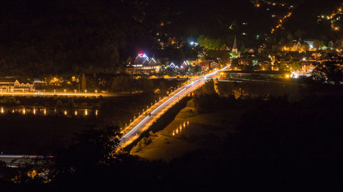 Light trails on river by city at night