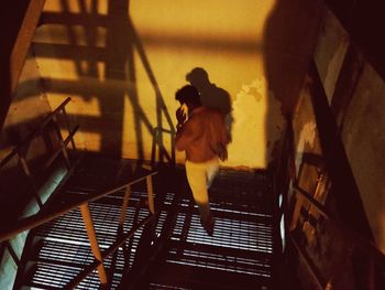 High angle view of woman standing on staircase