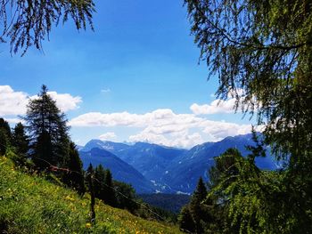 Scenic view of mountains against blue sky