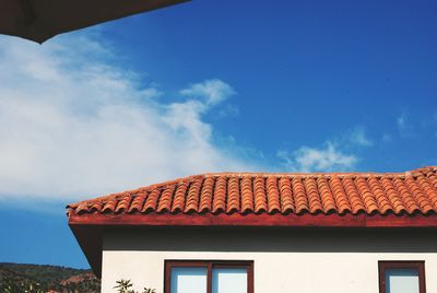 High section of house against cloudy sky