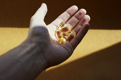 Close-up of human hand holding pills