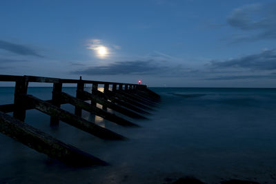 Pier over sea against sky